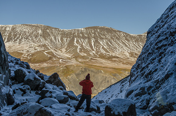 A University of Alaska Fairbanks geophysics student pauses to admire the view overlooking Atigun Gorge in the Brooks Range of Alaska.