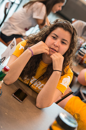Rachel Conley, a GeoFORCE counselor, chats idly with students while waiting to board a flight to Portland, Oregon.