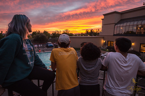After a long day of travel, students take a break to admire the Portland sunset.