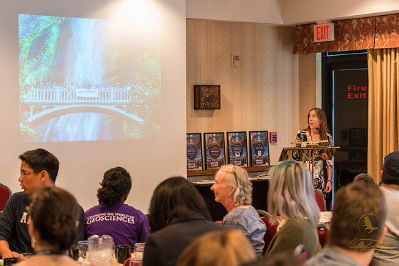 GeoFORCE Director, Sarah Fowell, presents a slideshow during the closing ceremony in Anchorage, Alaska.