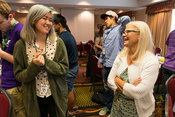 Cynthia Kim (left) chats with a friend who came to support her at the closing ceremony.