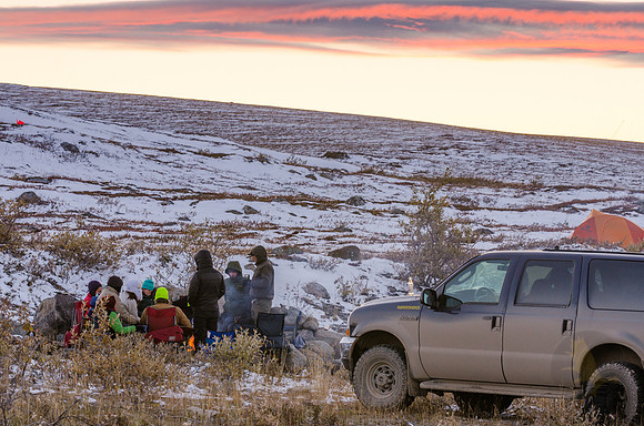 Students and professors enjoying dinner in the fading Alaskan sunlight.
