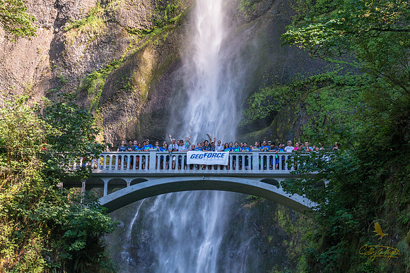 Oregon's Multnomah Falls sprays down on GeoFORCE students as they pose for a photo up on the foot bridge.