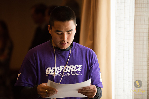 Alfred Omnik walks back to his seat after accepting his certificate of completion at the GeoFORCE Alaska closing ceremony in Anchorage, Alaska.