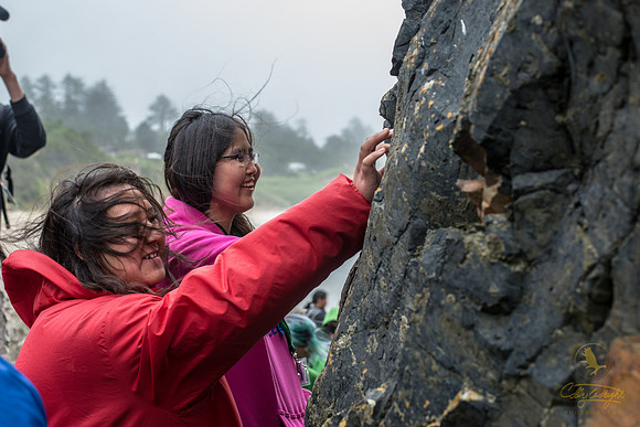 GeoFORCE students Lolo Driggs (left) and Ariel Bodfish (center) get up close to touch an ancient lava flow along the Oregon coast.