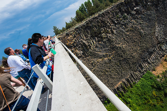Melvin Kagak leans over the rail to get a closer look at columns of basalt in the gorge walls.