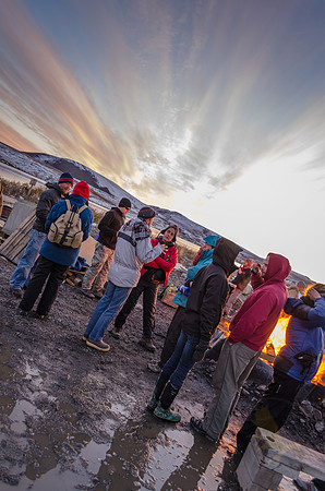 Students from the biology department mingle around a pallet fire with geology students at the Toolik Research Station just up the road from the geology campsite.