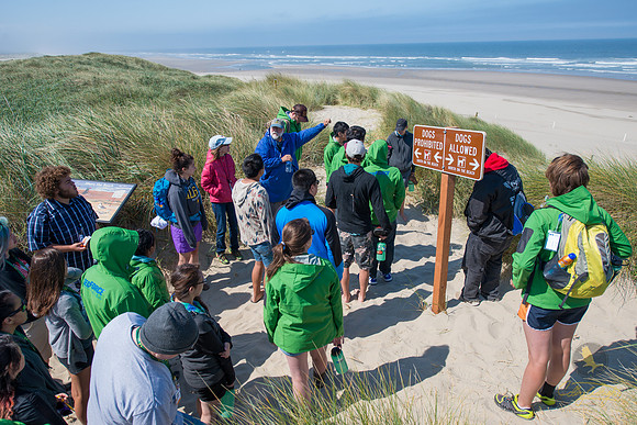 After an exciting race to the top of the dunes, students stop to catch their breath and listen to Dr. Jim Beget as he gives an overview about coastal processes.